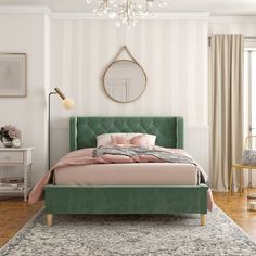 a bedroom with a bed, rug and chandelier on the wall above it