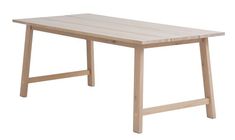 a wooden table sitting on top of a white floor