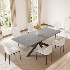 a dining room table with white chairs around it