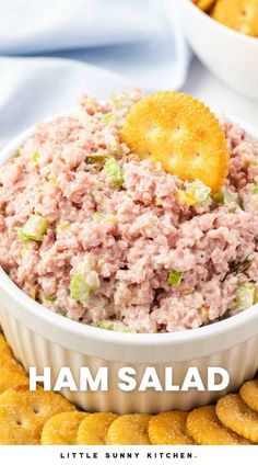 ham salad in a white bowl with crackers on the side and text overlay