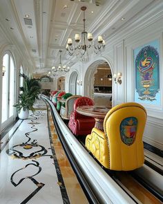 an indoor bowling alley with brightly colored chairs and chandeliers hanging from the ceiling