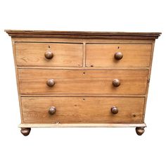 an old wooden dresser with knobs on the top and bottom drawers, isolated against a white background