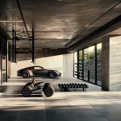 two cars are parked in the middle of a room with concrete walls and flooring