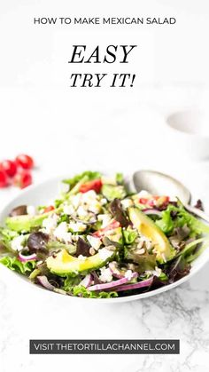 a salad with lettuce, tomatoes and olives on it in a white bowl