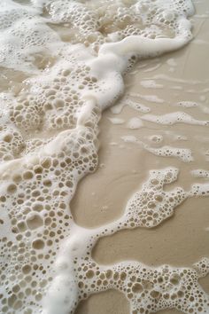 foamy water and sand on the beach