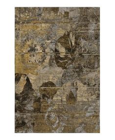 an area rug with various colors and patterns on it, including brown, beige, black and white