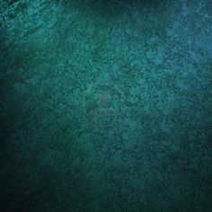 an aerial view of the ocean with green algae and blue water in the foreground