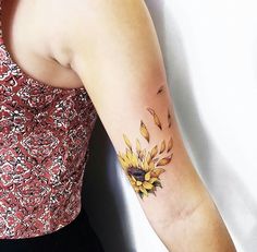 a woman with a sunflower tattoo on her arm