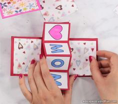 someone is making a card with the word wow on it and some hearts around it