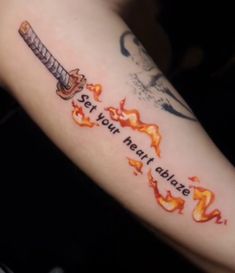 a person with a tattoo on their arm that says, set your heart on fire