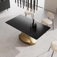 a black and gold dining table surrounded by white chairs