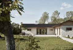 the house is surrounded by trees and grass