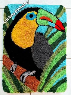 a colorful rug with a toucan bird on it's front and side