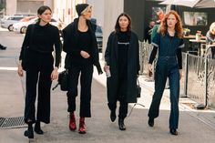 three women walking down the street together