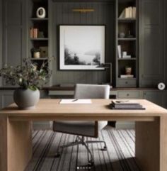 an office with gray walls and wooden furniture