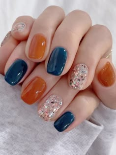 fall nails: caramel brown and dark blue with glitter Blue And Orange Gel Nails, Dark Blue And Orange Nails, Blue And Orange Nail Ideas, Orange And Blue Nails Design, Navy And Orange Nails, Nails Orange And Blue, Blue And Orange Nails Designs, Orange Blue Nails, Blue Orange Nails