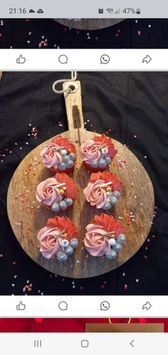 cupcakes are arranged on a wooden platter