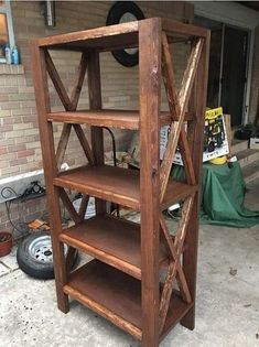 a wooden book shelf sitting on top of a sidewalk