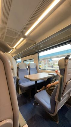 the interior of a train with two seats and a table in front of it that is empty