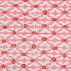 a pink and white fabric with red circles on it