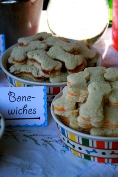 there are many different types of cookies in bowls on the table with name tags attached to them