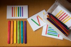 several different colored pencils sitting next to each other on top of a wooden table