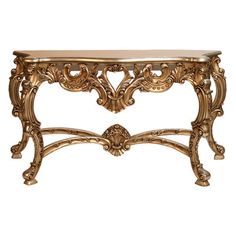 a gold console table with an ornate design