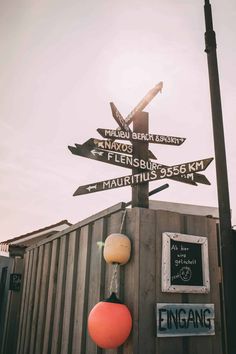 a pole with many different street signs on it