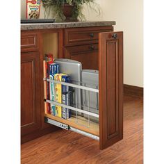 an open cabinet door in a kitchen with wooden floors