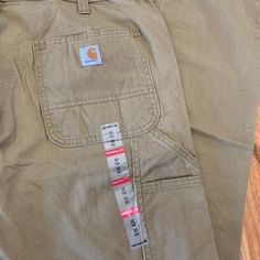 The Women's Original Fit Crawford Pant By Carhartt. Size 12 Tall. Measurements Approx: 14.5" Rise 17" Across Waist 33.5" Inseam Color Is Tan Womens Carhartt, Carhartt Scrubs, Carhartt Cargo Pants, Carhartt Carpenter Jeans, Painters Pants, Carhartt Womens, Carhartt Pants, Carhartt Women, Brown Pants