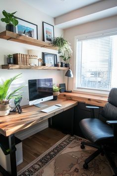 a desk with a computer, chair and potted plant in front of a window