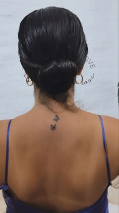 a woman with a butterfly tattoo on her back