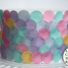 there is a cake decorated with pastel colors