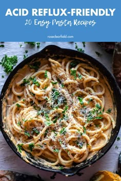 a skillet filled with pasta and topped with parsley