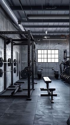 an empty gym with benches and weights