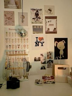 a white desk topped with lots of pictures and magnets