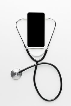 an electronic device connected to a stethoscope on top of a white table