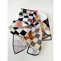 a pile of quilts sitting on top of a white table next to each other