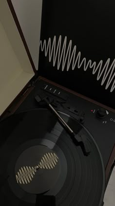 an old record player is sitting on top of the turntable and has a pair of tongs in it