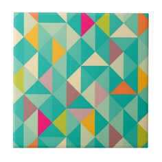 a colorful tile with many different shapes and colors on it's surface, including triangles