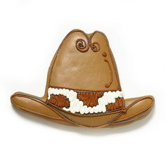 a brown cowboy hat with an animal on it