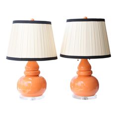 two orange lamps sitting next to each other