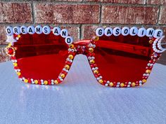 💗Who doesn't love Lainey Wilson and her Bell Bottom Country style? These custom DREAMS and GASOLINE red rectangle Sunnies 🕶️ are the perfect accessory for a concert or a night out! Enjoy these custom and one-of-a-kind sunglasses that include lots red and gold sparkles ✨! Each pair of bejeweled beauties comes wrapped tight because they are DELICATE. All pairs are hand made by a lifelong country music fan.  I am happy to make custom pairs! Please contact me if you want a different word or color combo! Please note that due to the unique nature of these sunglasses, no two are the same and there will be slight variations in specific gem color and placement. All will be very similar to the sunglasses in the photo and will be extra sparkly and lovely! 🤩 I hope you love wearing these as much as Bell Bottom Country, Heart Like A Truck, Beaded Sunglasses, Lainey Wilson, Red Rectangle, La Cloche, Unique Nature, A Truck, Music Fans