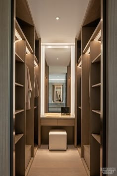 a walk - in closet with wooden shelves and lighting