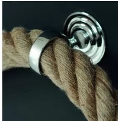 a close up of a rope with a button on it's end and a black background