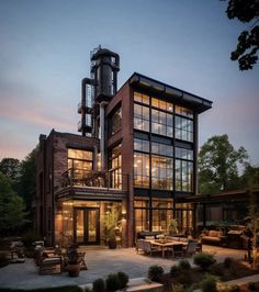 a large brick building with lots of windows on it's sides and an outdoor seating area