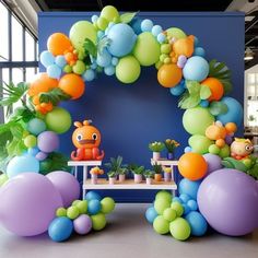 the balloon arch is decorated with balloons and other decorations for a children's birthday party