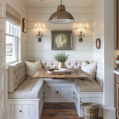 a room with a bench, table and clock on the wall