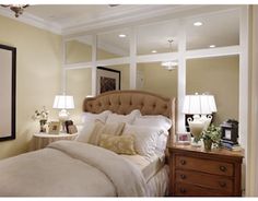 a bedroom with a large bed and two lamps on either side of the headboard