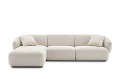 a large white couch with pillows on it's back and the seat folded out